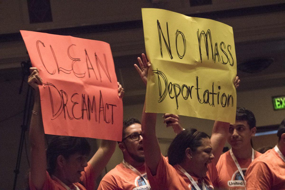 Protesters stand at the back of Hogg’s auditorium Sept. 24 shouting “Pass Dream Act” at U.S Sens. John Cornyn and Ted Cruz during the annual Texas Tribune Festival on the UT campus.Photo by Bri Watkins | Managing Editor