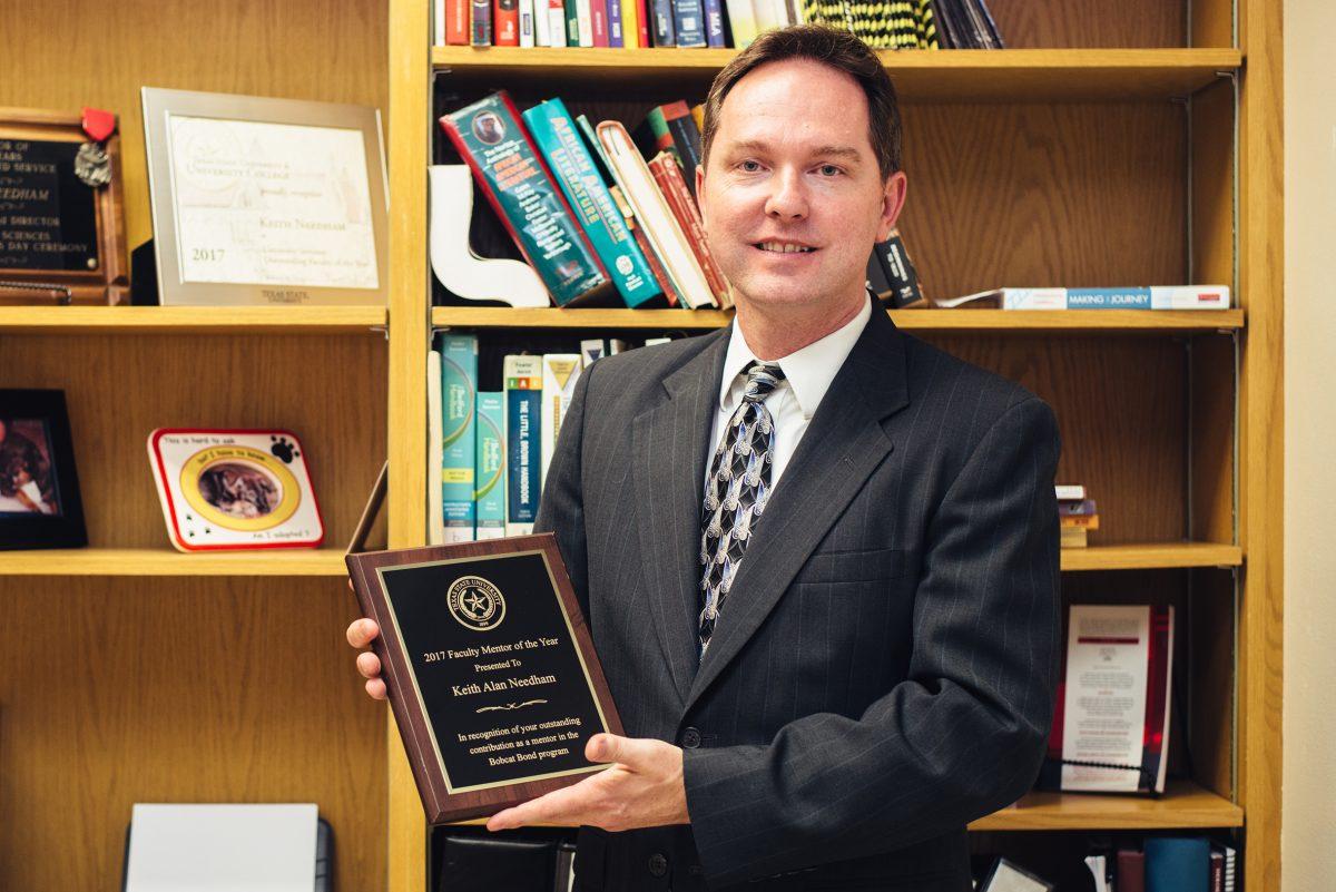 Keith Needham, professor at Texas State, proudly displays his 2017 Faculty Member of the Year Award Sept. 21. Needham is a mentor in the Texas State Bobcat Bond Program.Photo by Kirby Crumpler | Staff Photographer