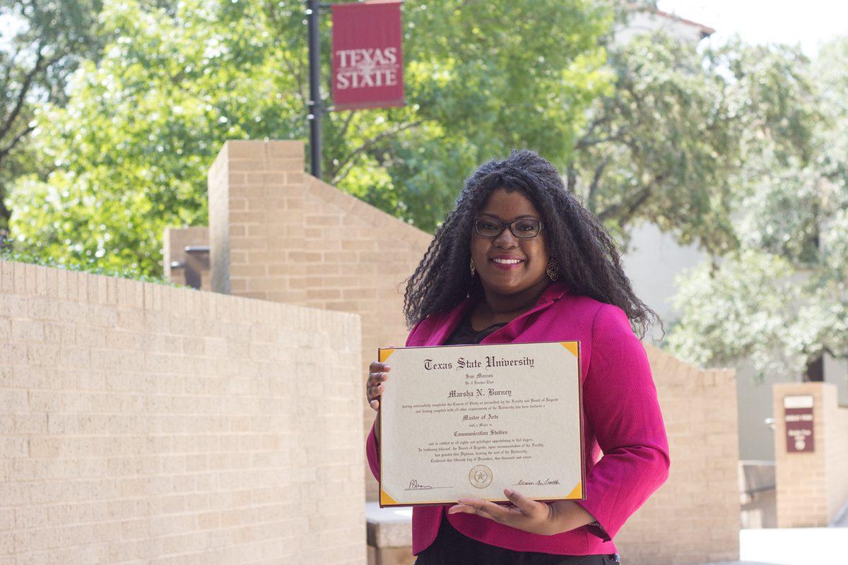 Marsha Burney, lecturer, poses with her degree in Communication Studies Sept. 1 near Centennial Hall. Burney is a Texas State alumna who has stayed here to teach for nearly ten years now.Photo by Lara Dietrich