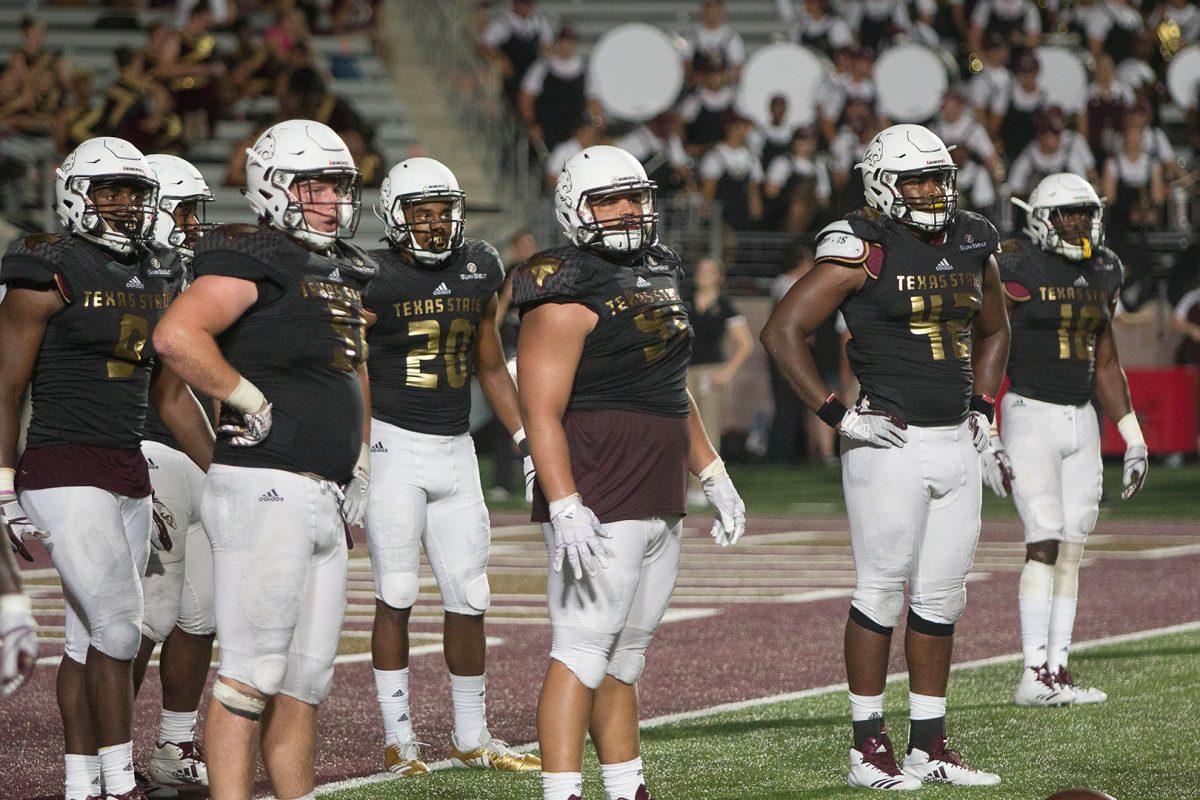 (Far right) Ishmael Davis, junior defensive end, watches his teammates Sept. 16during the game against Appalachian State at Bobcat Stadium.Photo by Josh Martinez | Staff Photographer