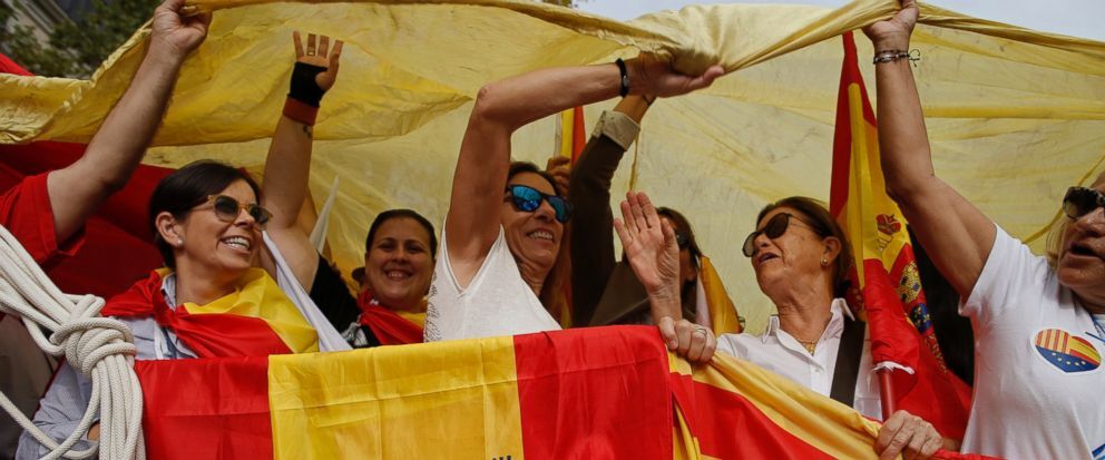 People hold the flags of Spain (left) and Catalonia (right) as they celebrate a holiday known as Dia de la Hispanidad.
Courtesy of Manu Fernandez from Associated Press