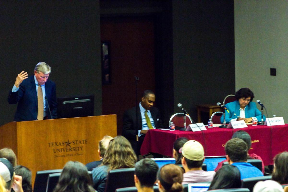 Retired Texas Supreme Court Justice Craig Enoch gives opening remarks to students Oct. 3 in LBJ Student Center Teaching Theatre. (Panelists from left to right: Craig Enoch, Ashton Cumberbatch and Lupe Valdez)Photo by Josh Mends | Staff Photographer