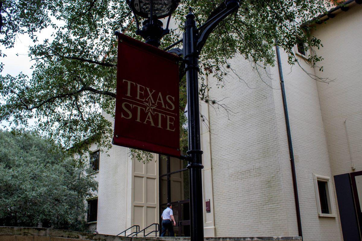 “Texas State” banner outside flowers hall Nov. 15. The Office of Community Relations is now linked with the office of the Dean of students.Photo by Josh Mends | Staff Photographer