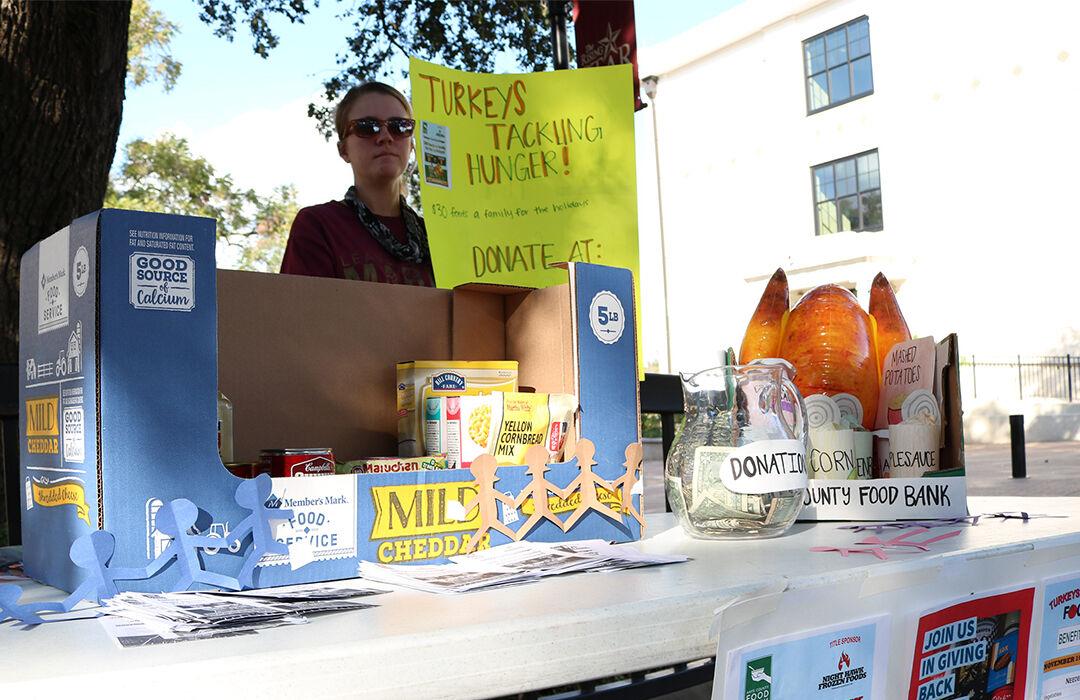A Hays County Food Bank volunteer hopes students can donate any spare change for families on the Quad. 1 in 7 Hays County Residents are food insecure.
Photo by Lexi Altschul | Staff Photographer
