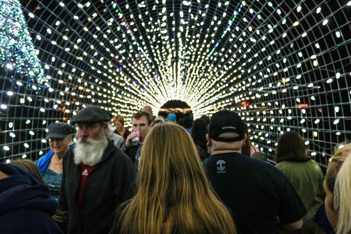 Festival goers walk through the light filled bridge at the Sights and Sounds of Christmas festival.Photo by Victor Rodriguez | Assistant Multimedia Editor