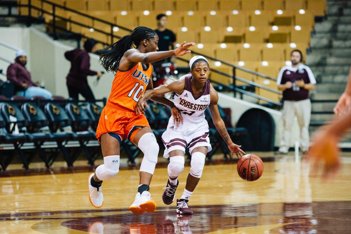 Dabrasia Baty, a junior guard for Texas State, moves the ball down the court during a game against UTSA at the Strahan Coliseum.Photo by Kirby Crumpler |Staff Photographer