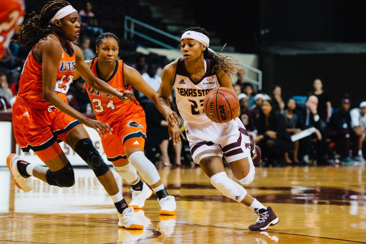 Texas State senior guard, Taeler Deer, moves up the court against defenders during Texas State’s 91-38 win over rival university UTSA on Dec. 5 at the Strahan Coliseum..Photo by Kirby Crumpler | Staff Photographer
