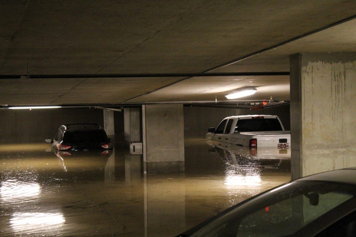 Vehicles in The Pointe apartment’s garage remain underwater after an overnight flood. 
