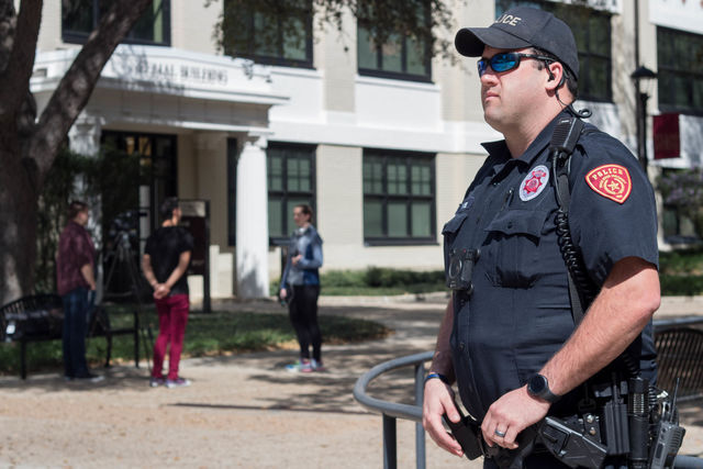 A UPD officer stands as a guard over Texas State University’s Quad.