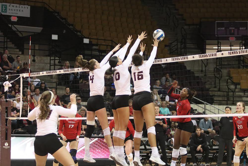 
Front row players, Cheyenne Huskey, Madison Daigle, and Janell Fitzgerald, triple block an Arkansas State player’s hit.


Photo By Kate Connors
