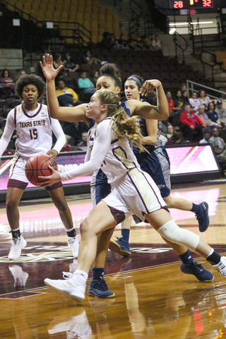 Brooke Holle pushes around a Georgia Southern defender in order to bring the ball to the basket. Photo by Kate Connors