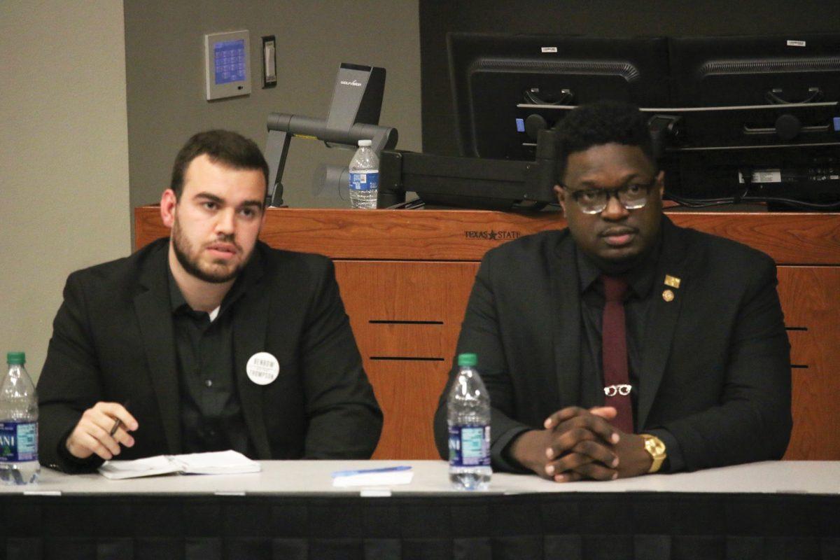 Presidential and vice presidential candidates Corey Benbow and Tucker Thompson listen to a student’s question at the presidential debate Feb.11 in the LBJ Teaching Theater. Photo by Jaden Edison