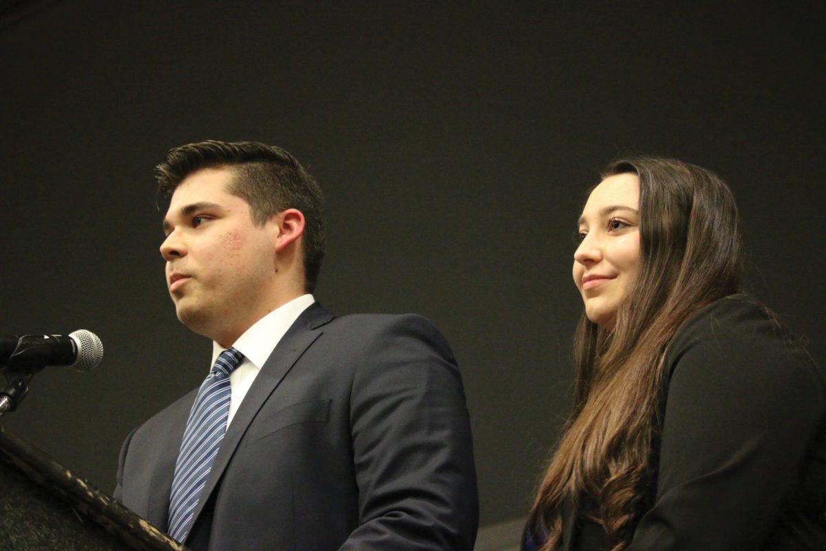 Presidential and vice presidential candidates Alex Plunkett and Kelly Torpey answer a student’s question at the presidential debate Feb.11 in the LBJ Teaching Theater. Photo by Jaden Edison