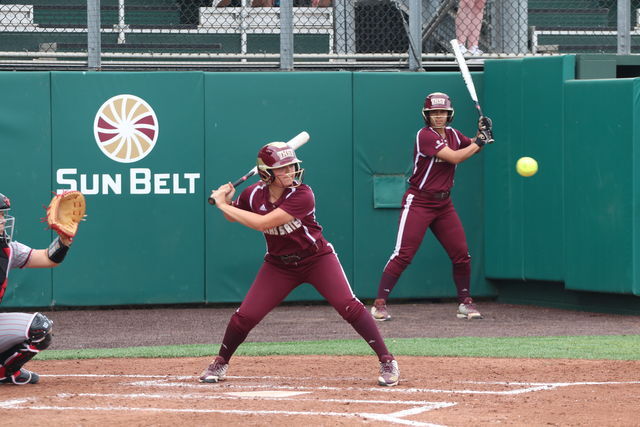 Freshman+Jordyn+Smith+eyes+the+pitch+before+moving+to+hit+the+ball.Photo+by+Kate+Connors.