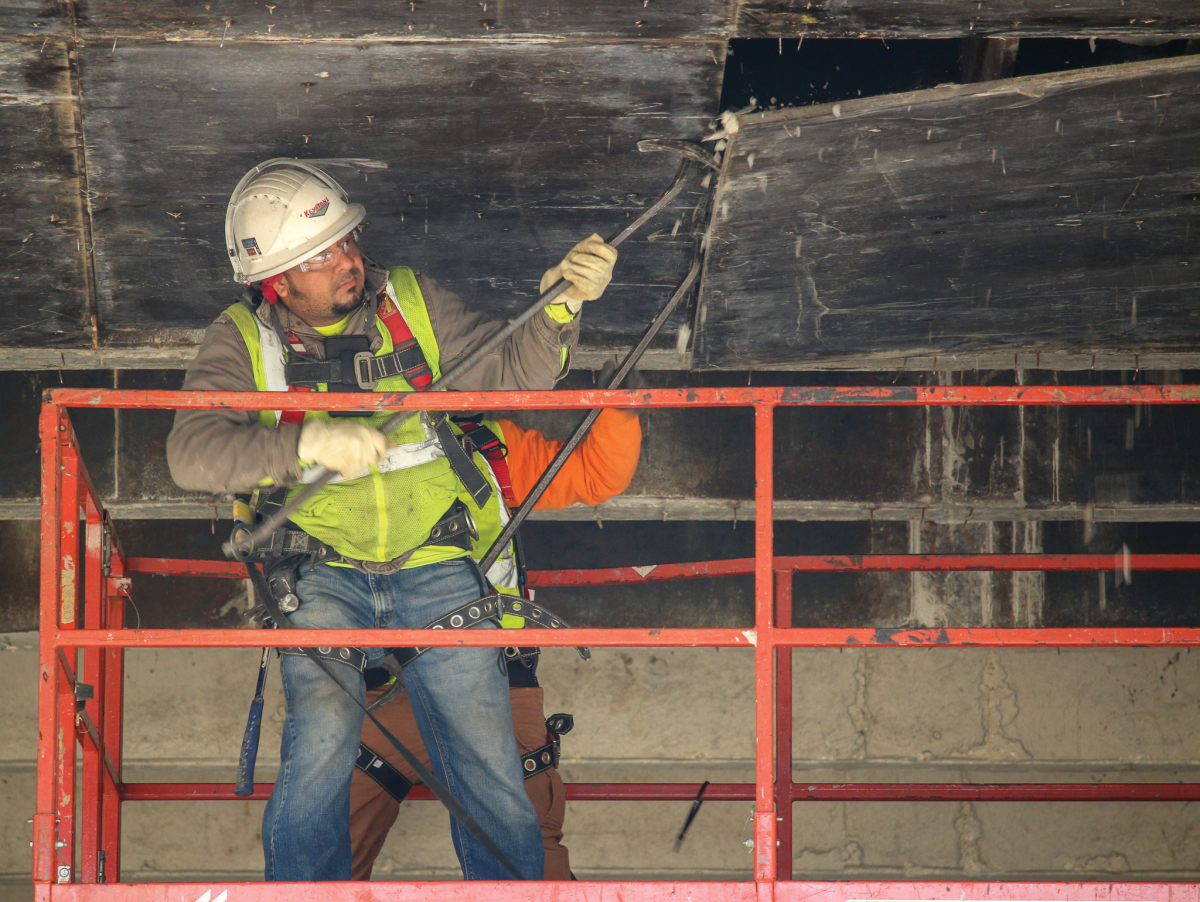 Construction workers tear board down March 11 at the LBJ Student Center.Photo by Jaden Edison