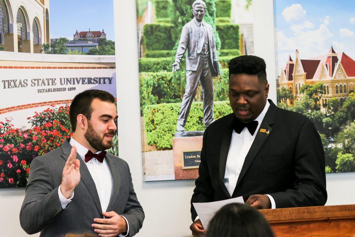 Former Student Government President Corey Benbow swears in his Vice President, Tucker Thompson, Thursday, April 18, 2019, in the LBJ Student Center.