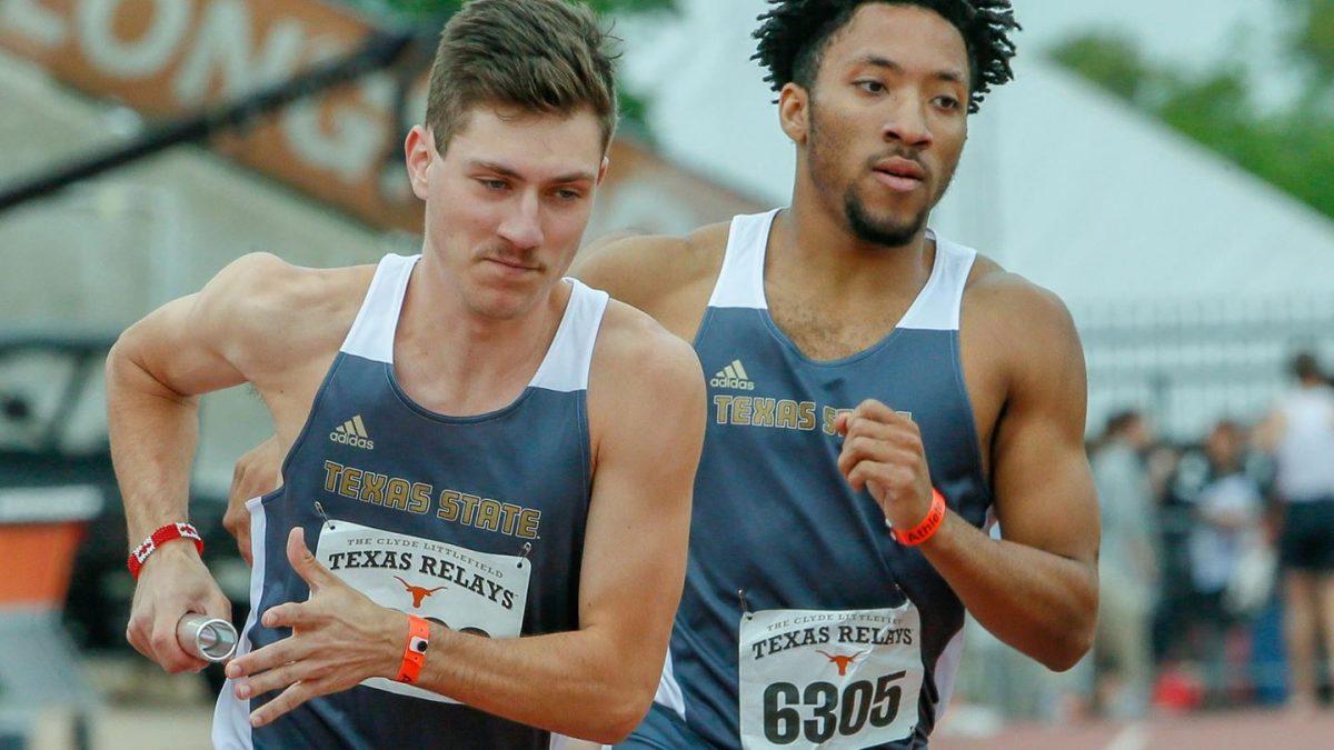 Kyle Denomme, senior track and field distance runner, is in baton transition March 27 with a relay team member at the Texas Relays in Austin, Texas. Courtesy photo by Texas State Athletics.