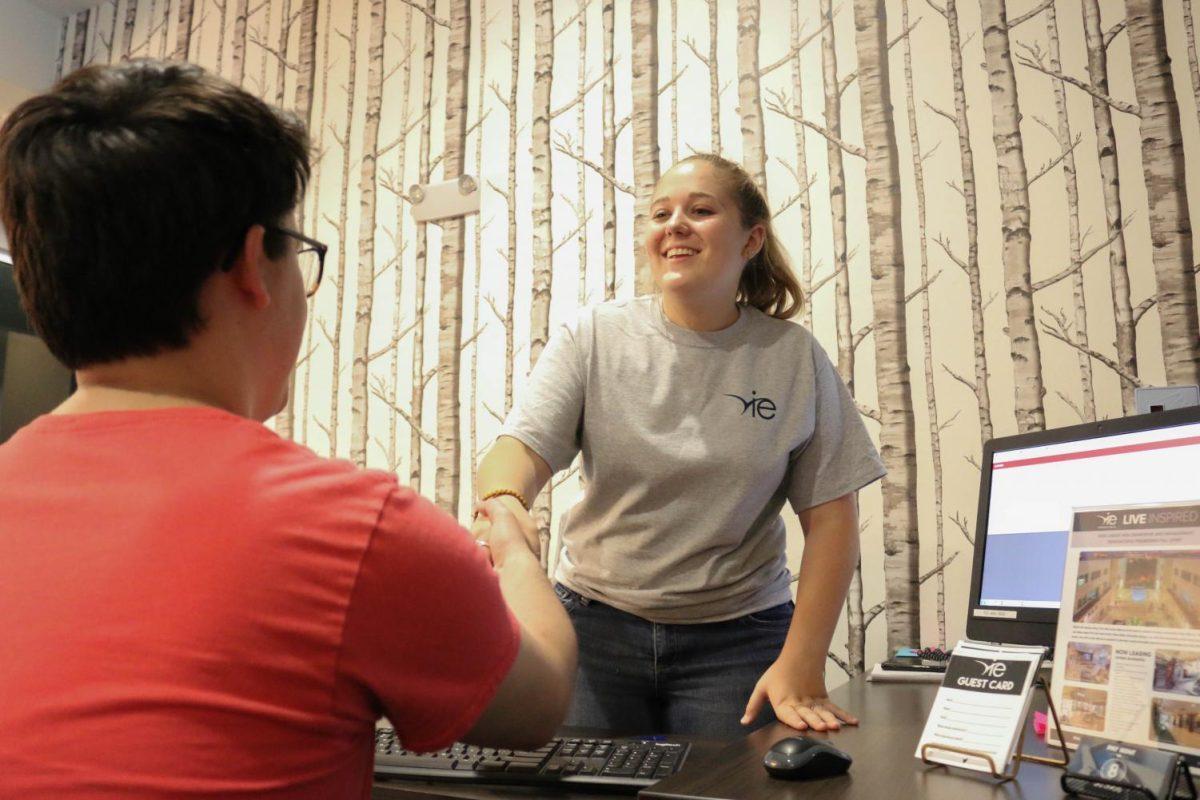 Vie Lofts employee Amanda Grimm shakes hands with Sean Schroeder after finalizing a lease agreement May 29 at Vie Lofts apartments.