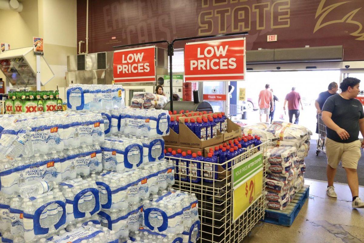 Water, charcoal lighters, coolers, alcoholic beverages and a barbecue pit, moved from individual aisles to the front of the store due to remodeling, sit on sale May 27 in HEB at 641 E Hopkins St.
