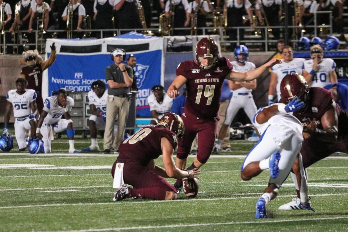 Senior Joshua Rowland kicks the game-winning field goal during the third overtime of the Georgia State game on Sept. 21 at Bobcat Stadium. Photo credit: Kate Connors