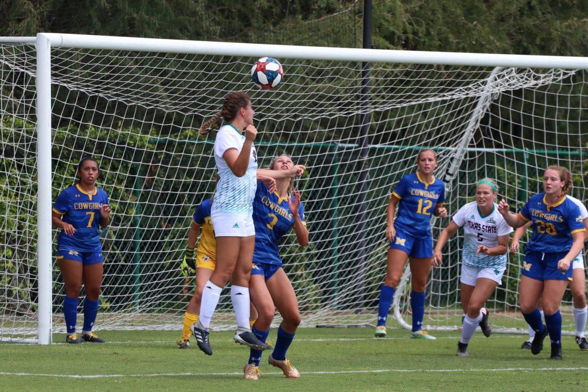 Junior defender Sarah Everett jumps in an attempt to head the ball in the direction of the goal, Sunday, Sept. 15, 2019, in a game against McNeese at Bobcat Soccer Complex.