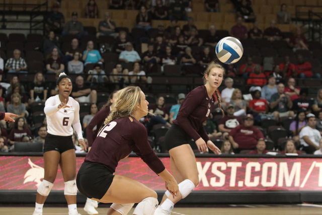 Brooke Johnson passes the volleyball to the setter at their game against the Liberty Flames at Strahan Arena.