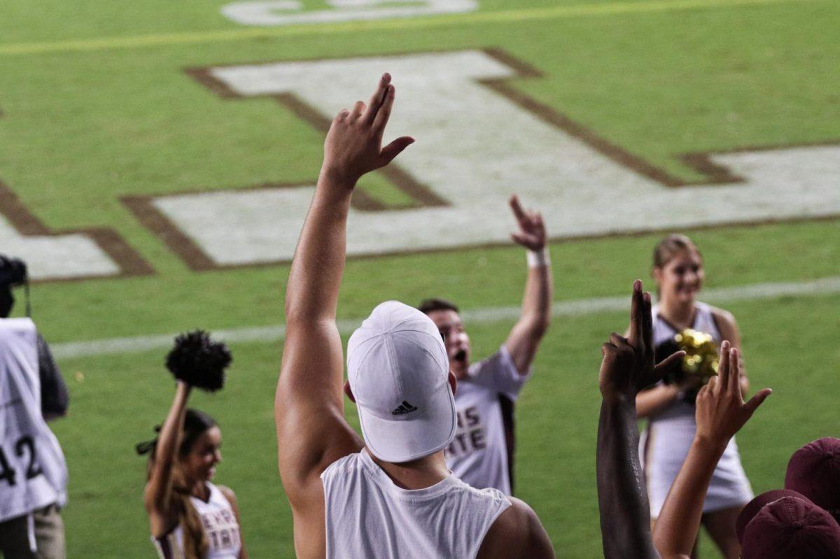 A Texas State student follows along with the cheerleaders to show support for the Texas State football team, Thursday, Aug. 29, 2019, at the football game against Texas A&M at Kyle Field in College Station, Texas. [Photo by Kate Connors]