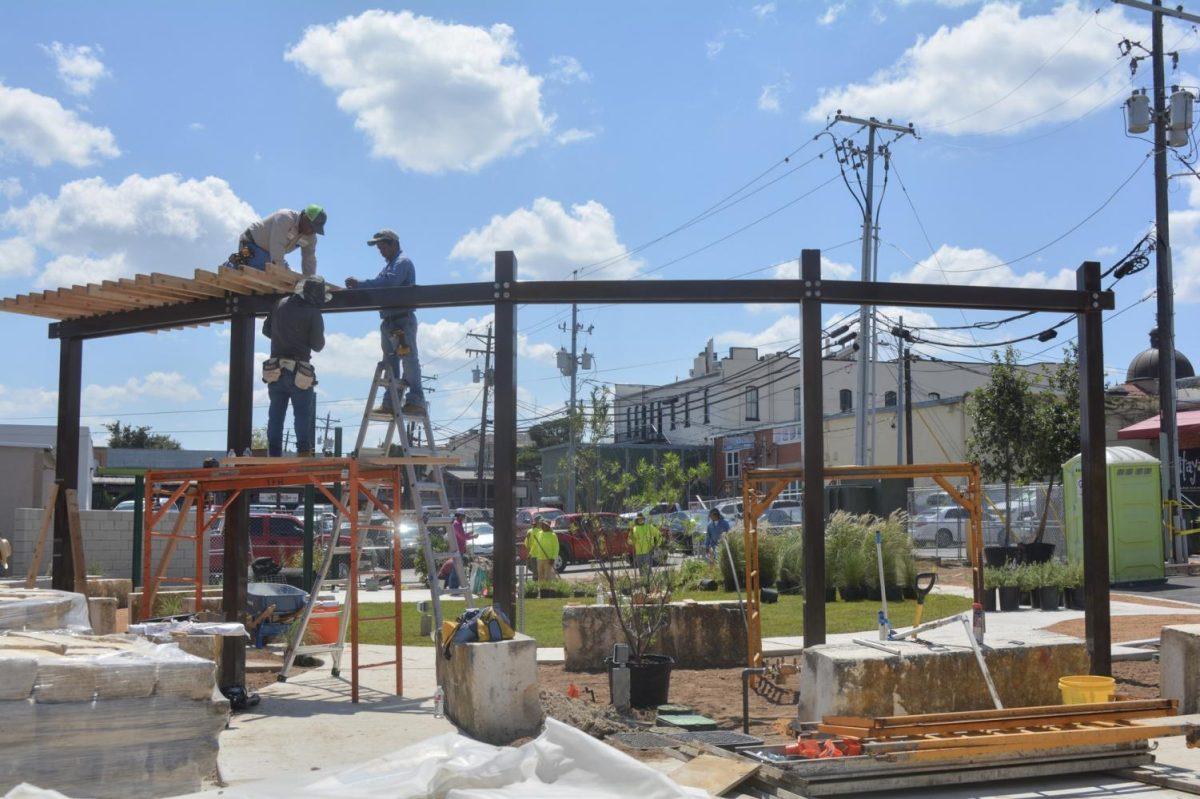 Construction workers Ever Cruz (left), Efrain Alvarez (middle) and Yovanni Alvarez (right) work on the soon-to-be-finished Mobility Hub Sept.13 on 214 E. Hutchison Street. Photo credit: Angelina Cazar