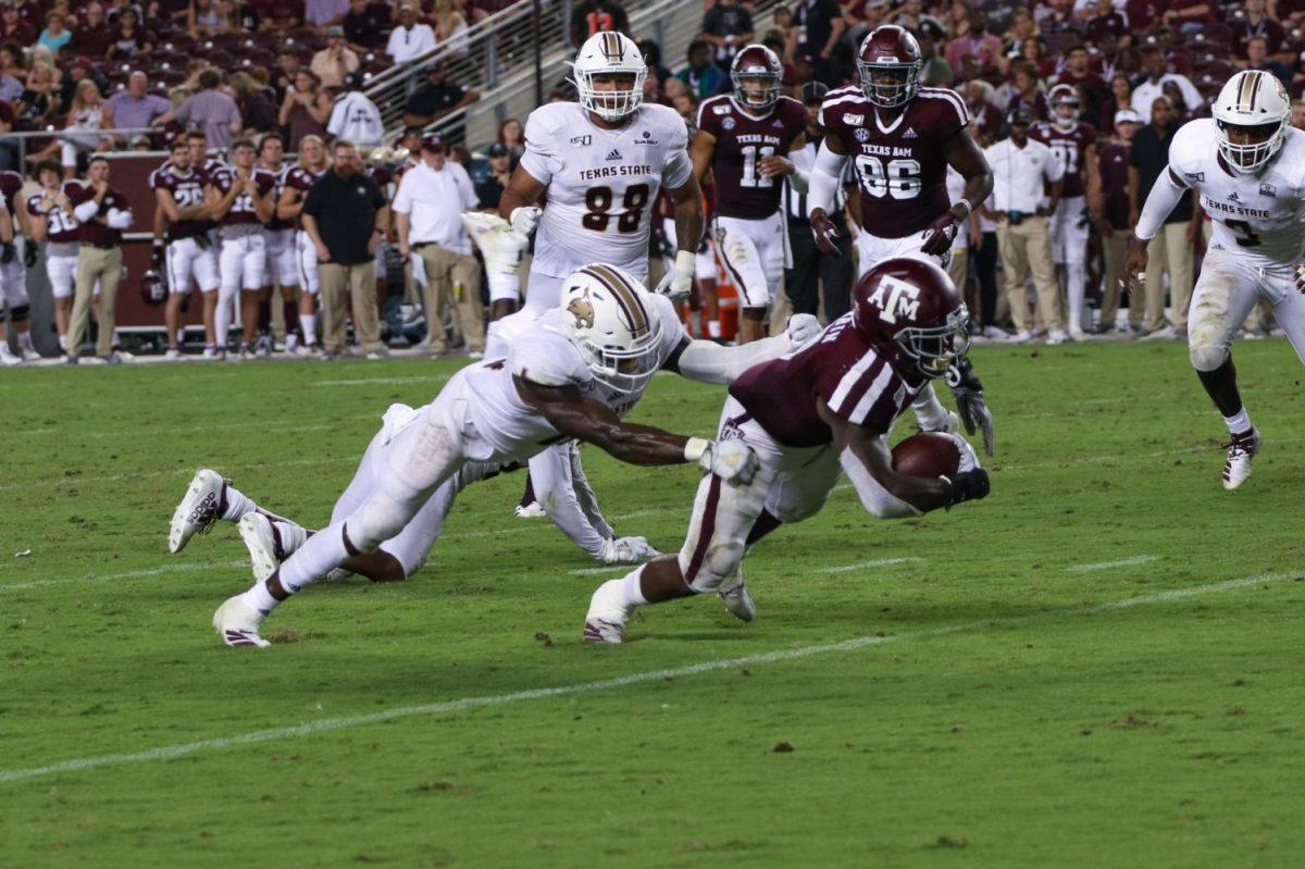 Texas State linebacker Frankie Griffin lunges to take down a Texas A&M running back, Thursday, Aug. 29, 2019, at Kyle Field in College Station, Texas. The Aggies went on to defeat the Bobcats 41-7. [Photo by Kate Connors]