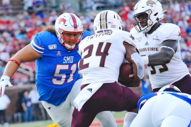 Texas State junior wide receiver Caleb Twyford weaves between the SMU defense, Saturday, Sept 14, 2019, at Gerald J. Ford Stadium in Dallas.