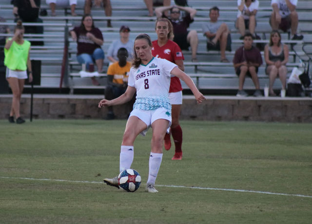 Junior midfielder Renny Moore dribbles downfield in the Bobcats’ first conference game.