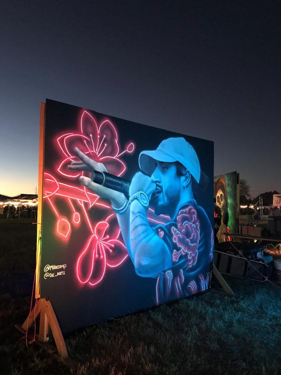 Artist Mike Comp, creates a live, neon, spray painted mural of Russ for the festival goers to watch and enjoy.