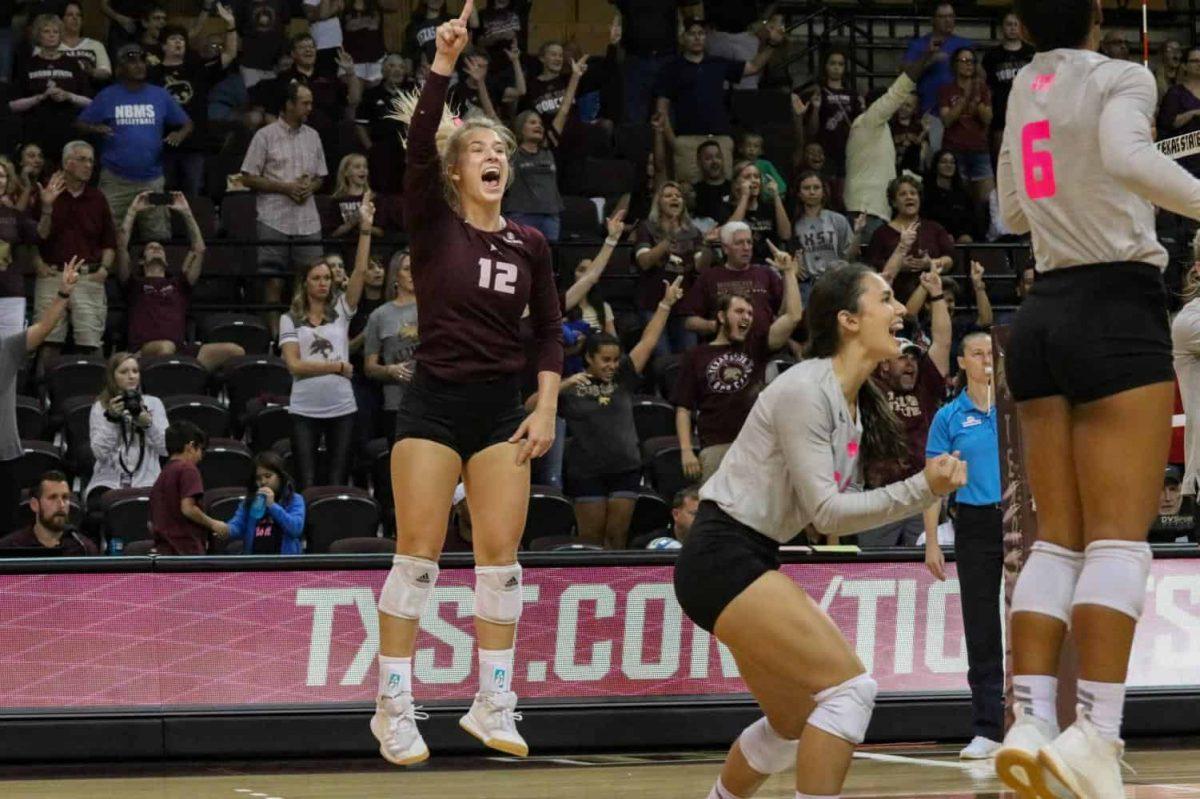 Junior Brooke Johnson, (12), celebrates with her teammates after the set winning point was scored against South Alabama, Saturday, Oct. 19, 2019, at Strahan Arena. Texas State defeated South Alabama 3-1. Photo credit: Kate Connors