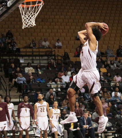 Quentin Scott jumps to dunk the ball Nov. 1 at Strahan Arena.