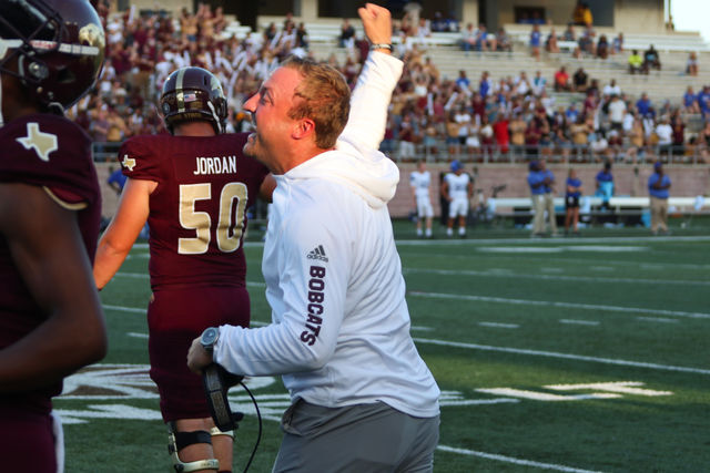 Head coach Jake Spavital celebrates and runs to the field after the Bobcats score off a fumble recovery during the first quarter of the Georgia State game on Sept. 21 at Bobcat Stadium.