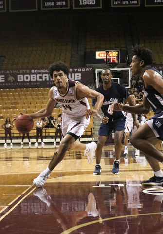 Junior Quentin Scott dribbles around Jackson State players to get open and shoot a basket Nov. 18 at Strahan Arena.