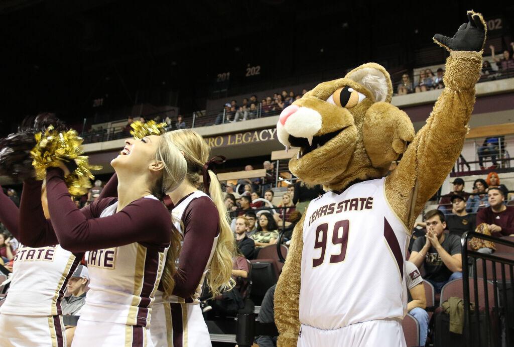 Texas State mascot Boko the Bobcat raises a claw in the air during a Texas State basketball game vs. UTA, Saturday, Jan. 25, 2020, at Strahan Arena.