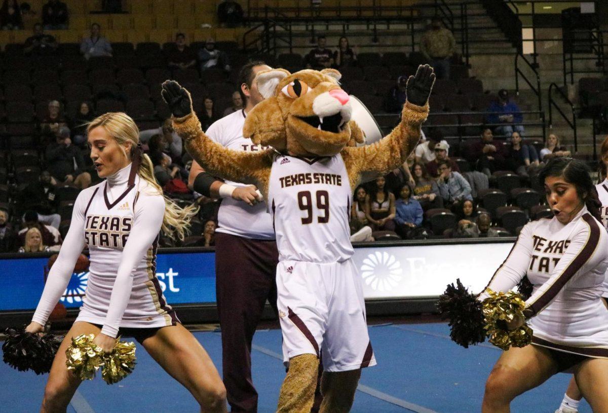 Boko the Bobcat cheers with the Texas State cheerleading squad during the halftime performance of the men’s basketball game vs. Appalachian State, Saturday, Jan. 11, 2019, at Strahan Arena.