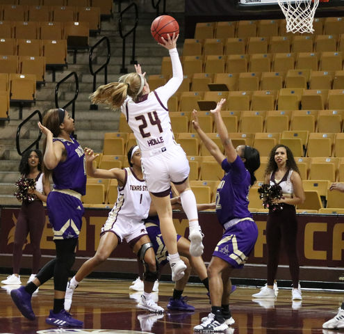 Senior Brooke Holle jumps and shoots the ball over Alcorn State defenders to increase the Bobcat’s lead Dec. 30 at Strahan Arena. Holle reached the ninth-place all-time spot in program history for three-pointers against Louisiana on Saturday. Photo by Kate Connors.