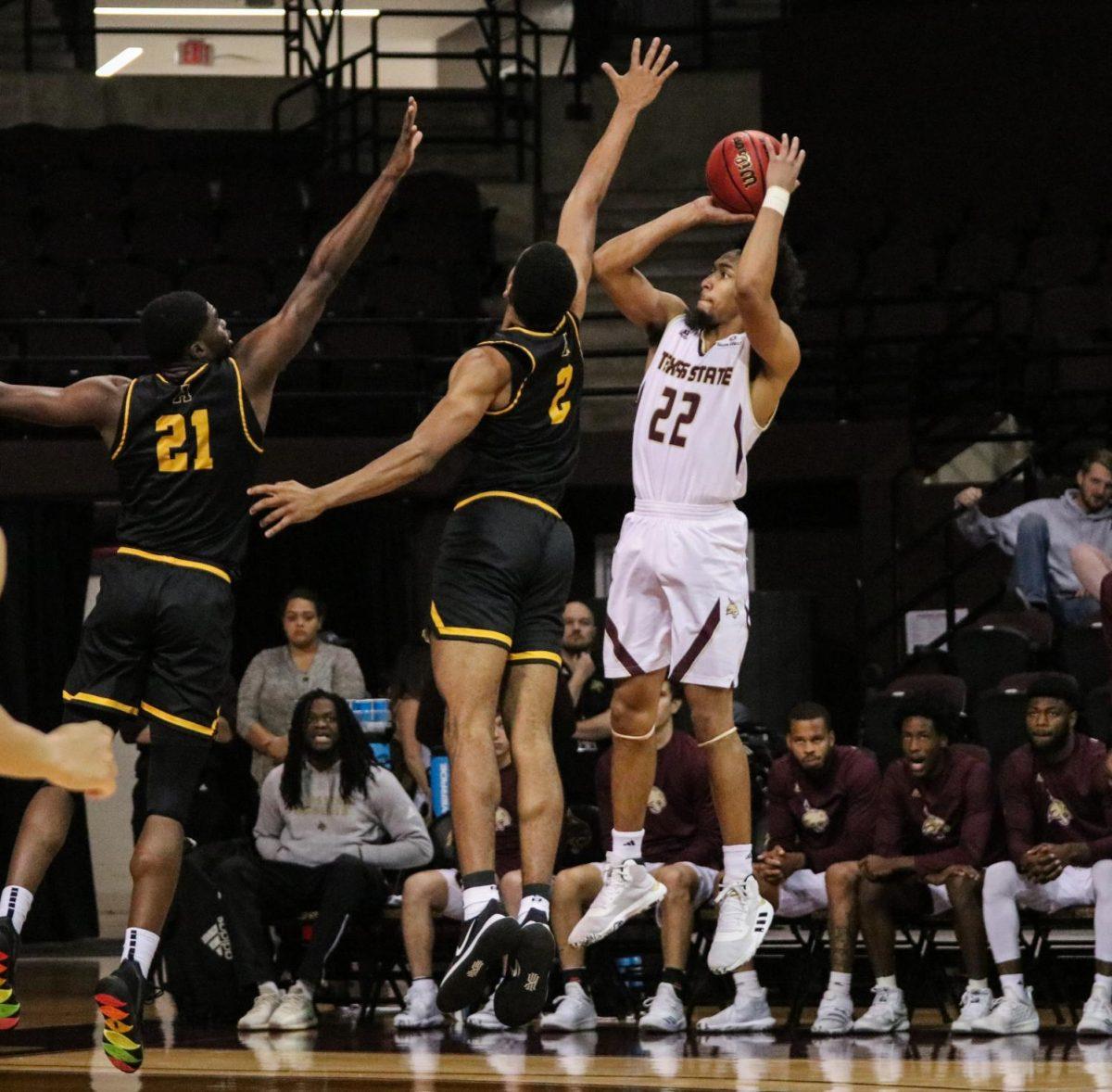 Senior guard Nijal Pearson, (22), shoots a three-pointer during the second half of a game against Appalachian State, Saturday, Jan. 11, 2019, at Strahan Arena. After scoring 22 points, Pearson is only a few points from becoming the all-time scorer at Texas State.
