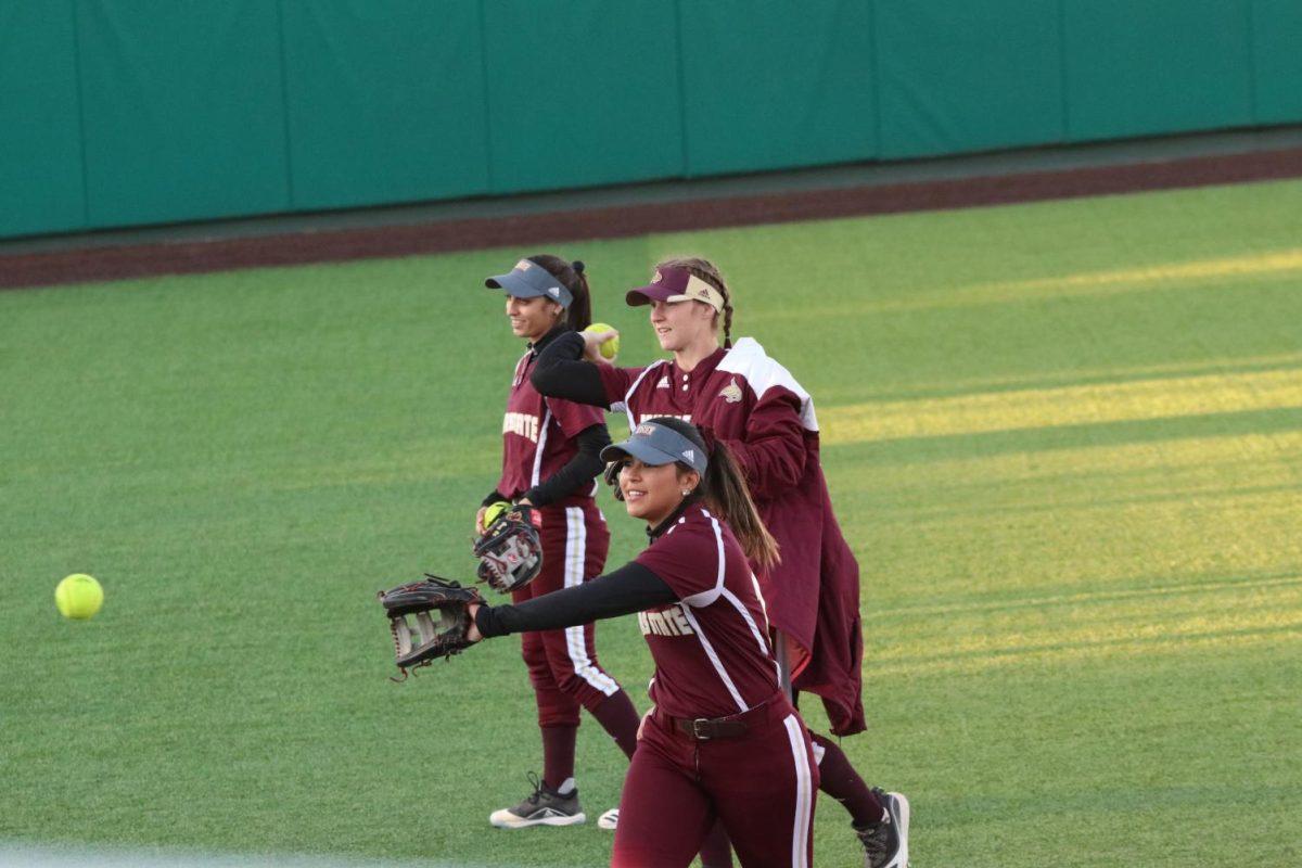 The Texas State softball team warms up prior to the first inning of a tournament game against Saint Louis, Friday, Feb. 14, 2020, at Bobcat Softball Stadium.
