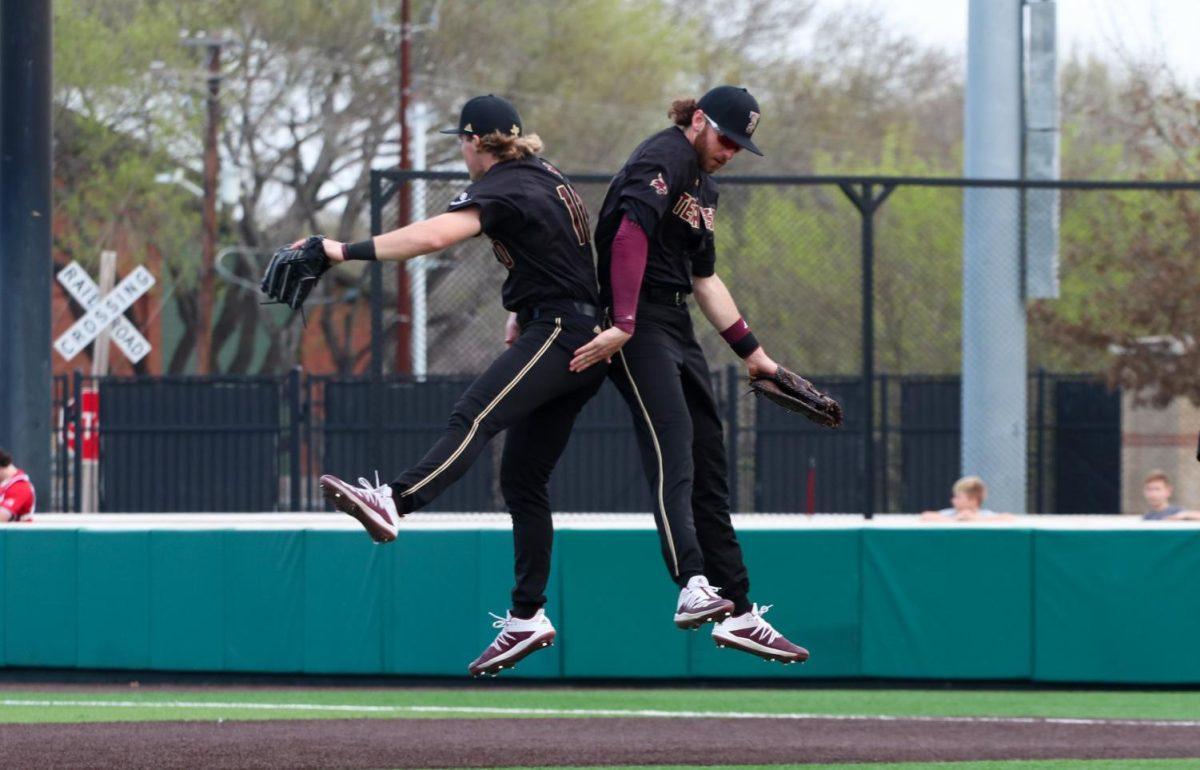 Texas State senior infielder Cole Coffey and junior infielder Justin Thompson jump to celebrate a 4-3 win over Stony Brook, Sunday, Feb. 16, 2020, at Bobcat Ballpark.
