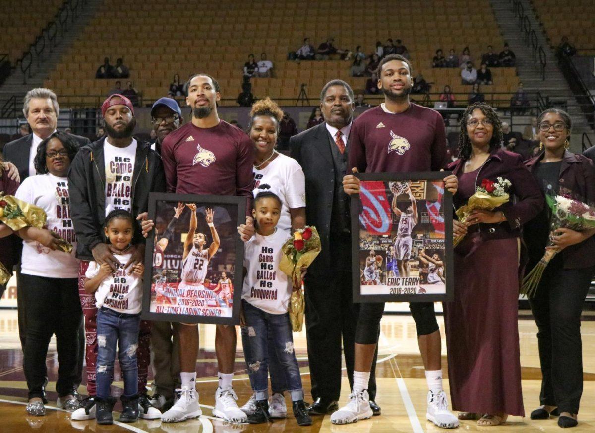 Texas State seniors Nijal Pearson and Eric Terry pose for a photo with their families during the players’ senior night, Saturday, Feb. 22, 2020 at Strahan Arena.