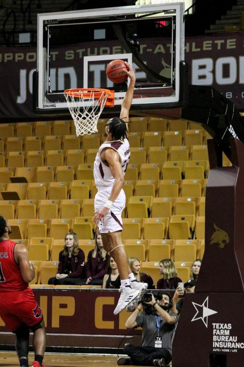 After a fast break down the court, Texas State senior guard Nijal Pearson dunks to increase a lead over Arkansas State, Saturday, Feb. 15, 2020, at Strahan Arena.