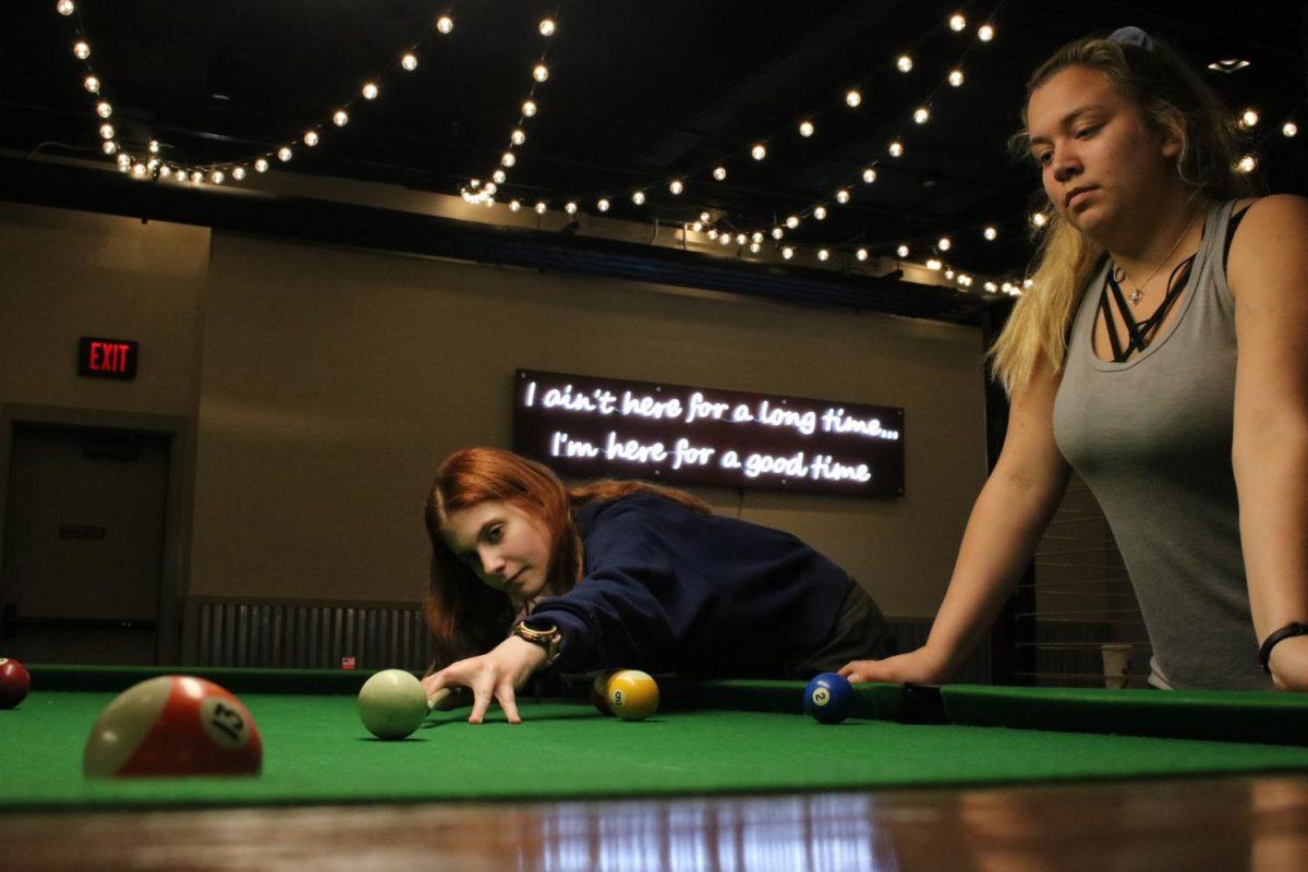 Texas State students Alexis Acree (left) and Lauren Spate play a round of pool, Wednesday, Feb. 20, 2020, at George’s in the LBJ Student Center. (Hannah Thompson)