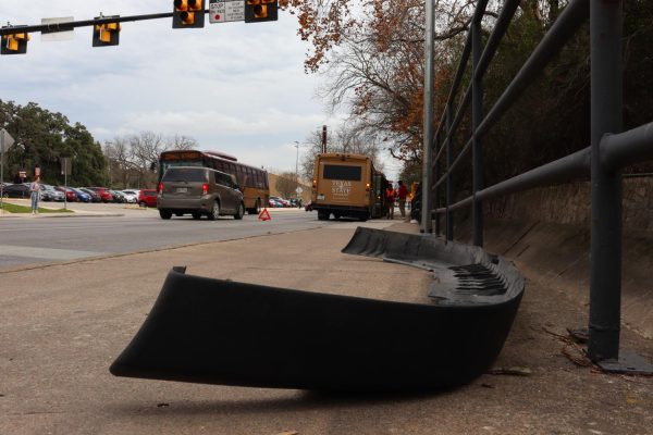 A front lower valence sits on the sidewalk along with debris from the collision between two Texas State Shuttles Feb. 3, 2020, on Sessom Drive.