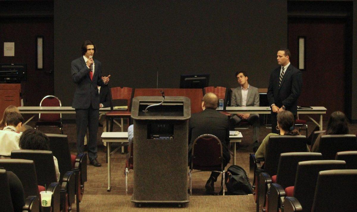 Presidential candidate Catching Valentinis-Dee (left) and presidential candidate Cory DeSalvo (right) speak during the presidential portion of the Student Government Presidential Debate, Monday, Feb. 10, 2020, in the LBJ Teaching Theater.