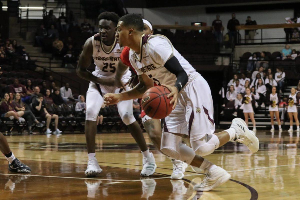 Texas State point guard Marlin Davis dribbles the ball around Louisiana players to get the ball to an open teammate, Saturday, Feb. 1, 2020, at Strahan Arena.