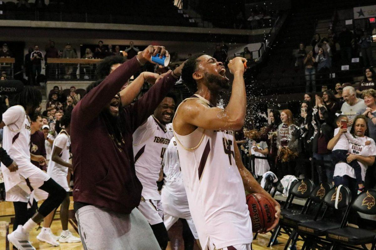 Texas State senior forward Eric Terry gets drenched with water by his teammates after a team win on his senior night, Saturday, Feb. 22, 2020, at Strahan Arena. Texas State defeated Georgia State 86-76 to move to second in the Sun Belt conference.