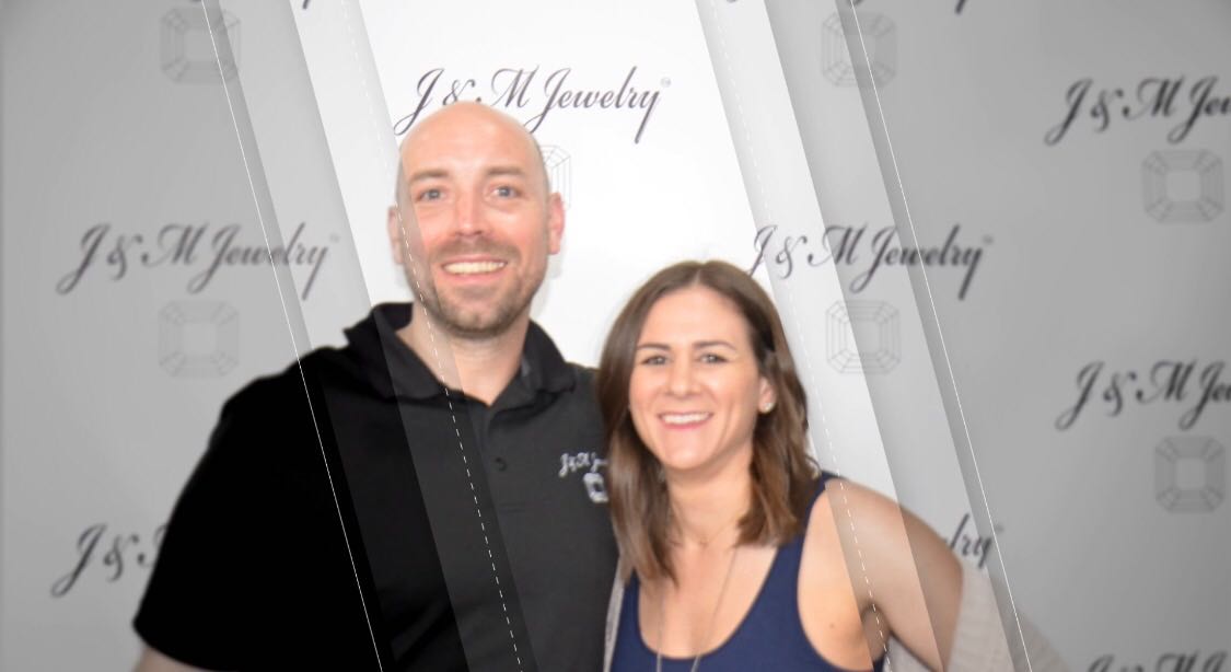 Owner of J&M Jewelry, Cory Moore, with his wife, Michelle Gabay-Moore at the Houston Customer Appreciation Event standing in front of the J&M Jewelry premiere backdrop.